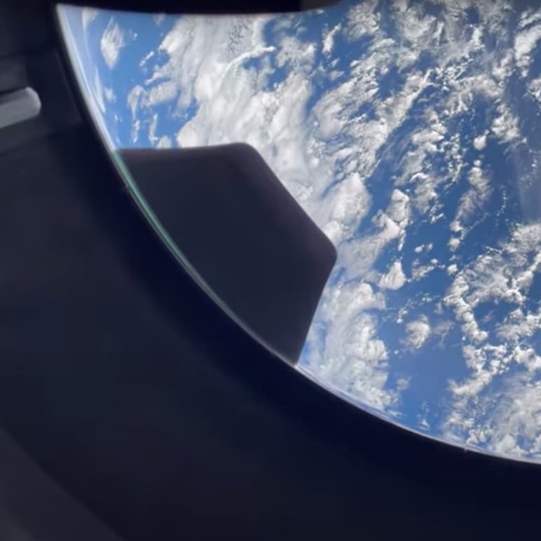 Image of Earth as viewed through a porthole
